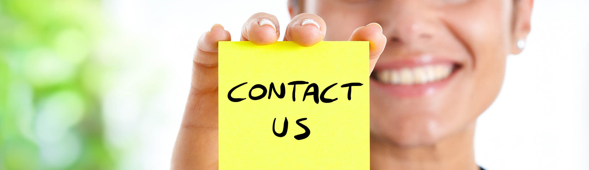 businesswoman showing "contact us" text on a post-it